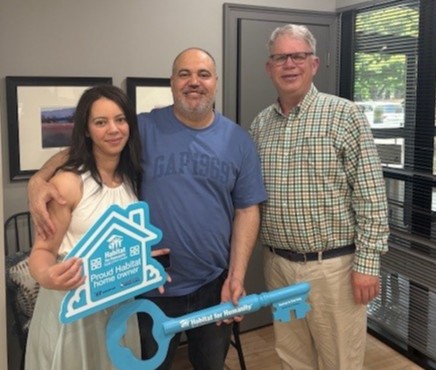 Family receiving keys to their new Habitat for Humanity home