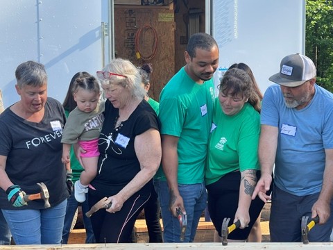 Habitat partner family and volunteers building together
